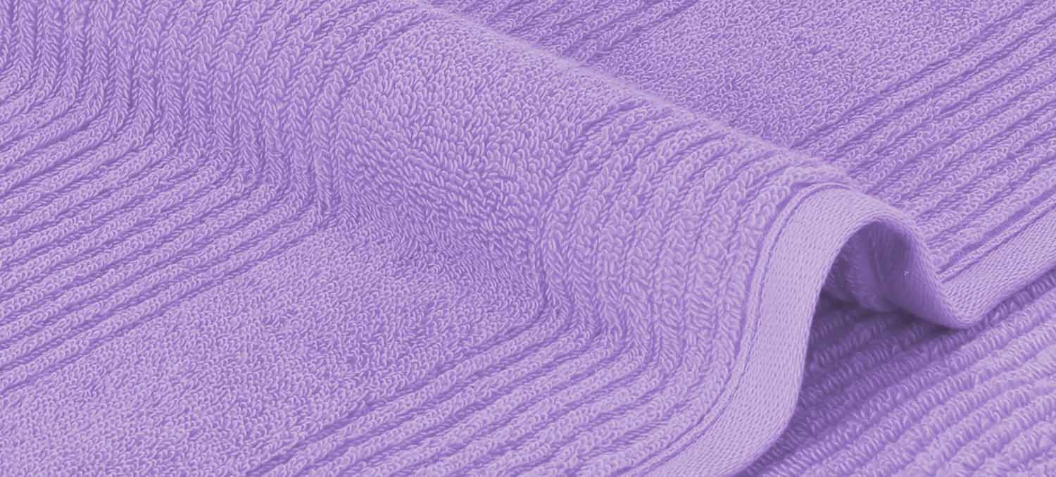 Nahaufnahme eines lila Handtuchs mit strukturierter Oberfläche und gefalteten Kanten.